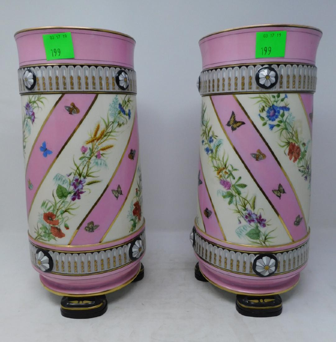 Pair Vieux Paris Porcelain Mantle Vases: Pair Vieux Paris Porcelain Mantle Vases: A large and exuberant pair of Old French Porcelain vases in the Renaissance Revival style. Of cylinder form, on three feet; applied rosettes. Decorated in pink