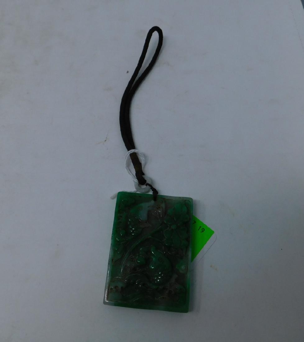 Chinese Jadeite Rectangular Plaque: Chinese Jadeite Rectangular Plaque: A rectangular piece of jadeite in a good strong green color with some white spots, carved in relief with two fish and plant motifs on one side, a flower on the othe