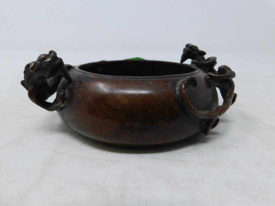 Chinese Bronze Incense Burner: Chinese Bronze Incense Burner: A small incense burner of cupped form in cast bronze, decorated with two stalking panthers. Character mark. Size: 4.5" across, 1.75" tall. [19] CONDITION: usual marks to