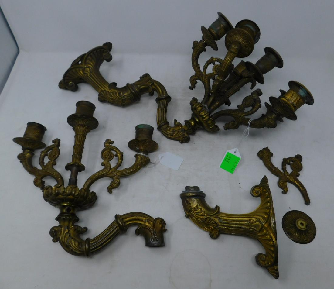 French Ormolu Bronze Wall Sconces: French Ormolu Bronze Wall Sconces in the Napoleon III style; six-lite candelabra of elaborate and scoll and foilate form. Size: approx 15" long overall and 13" tall. CONDITION: One sonce needs one arm