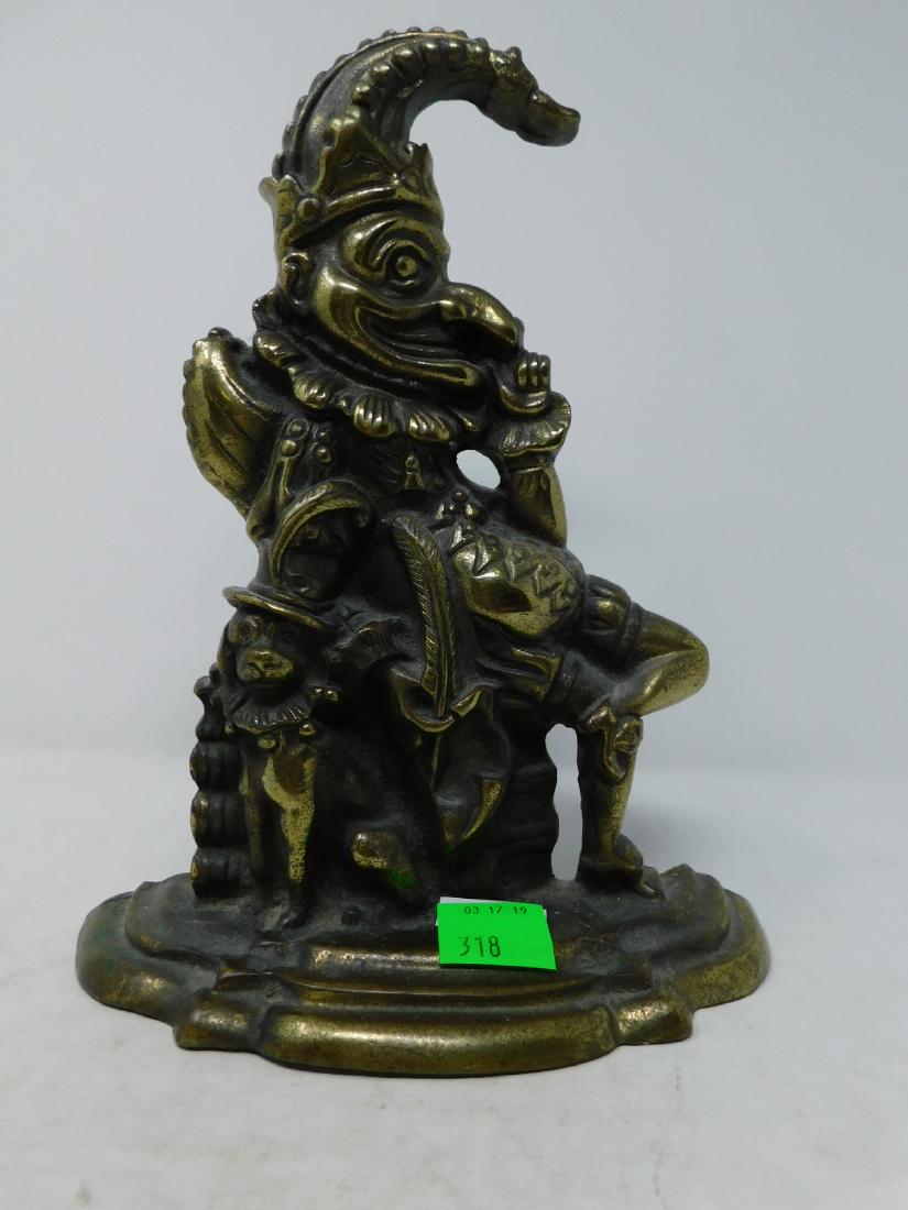Cast Brass Punch Figural Doorstop: Cast Brass Punch Figural Doorstop: A cast brass doorstop in the form of the character Punch of Punch & Judy, seated with his dog, Toby. Probably English, 20th century. Size: 11.125" tall. CONDITION: L