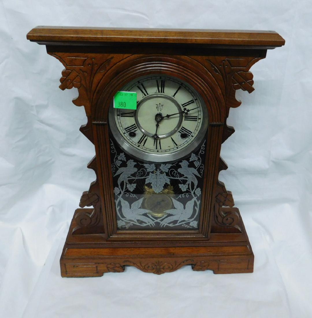 Wm Gilbert Gingerbread Clock: Wm Gilbert Ginger Bread Clock, walnut with incised scroll work, paper dial on tin, bird stenciled glass door, time and strike brass movement with keys and late 19th C., 17 1/2" h, 14 1/4"l. CONDITION: