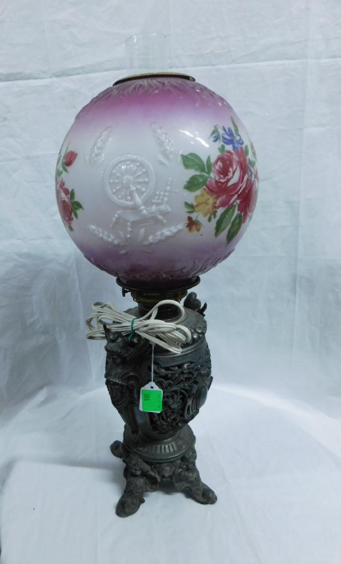 Gone With The Wind Fluid Lamp: Gone With The Wind Fluid Lamp, open work cast spelter metal font and base featuring winged maidens, Putti masks, scrolls and cartouches, painted glass ball shade with flowers and embossed spinning whe
