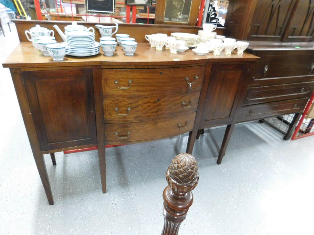 Hepplewhite Style Sideboard: Hepplewhite Style Sideboard, figural mahogany with string inlays, bale brasses, slightly bowed center, features three drawers, flanked by two paneled doors all with locks and key; tapered square legs,