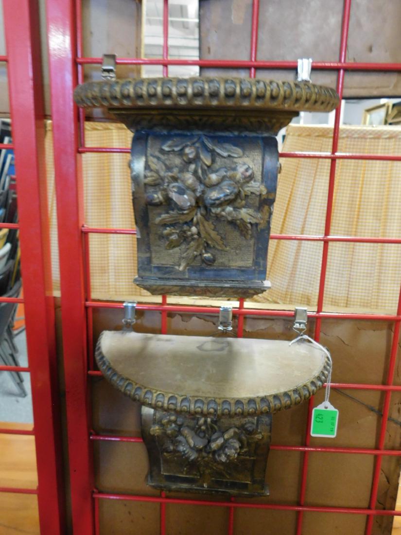 Pr Antique Wall Brackets: Pair Antique Wall Brackets, original gilt over wood, original cloth inset demi lune tops on rose carved and scalloped brackets, 18th / 19th C, 10 1/2" x 5 1/2" x 9". CONDITION: Gilt wear and chipping.