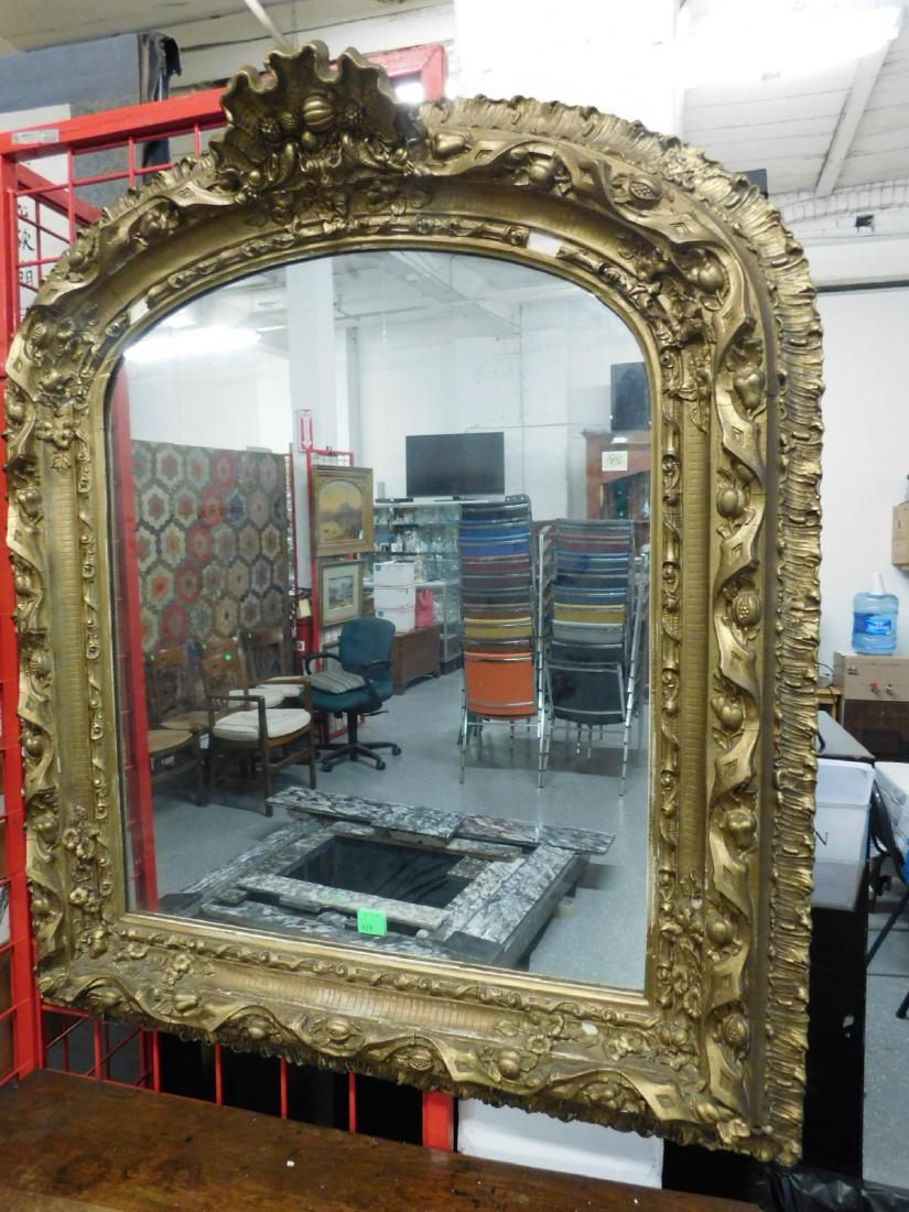 Transitional Rococo Mirror: Transitional Rococo Mirror, gilt and gessoed carved, arch top with raised shell, berry and scroll crest, multiple tiered borders featuring fruit, ribbons, flowers, etc. circa 1850, 36 1/2" x 40". COND