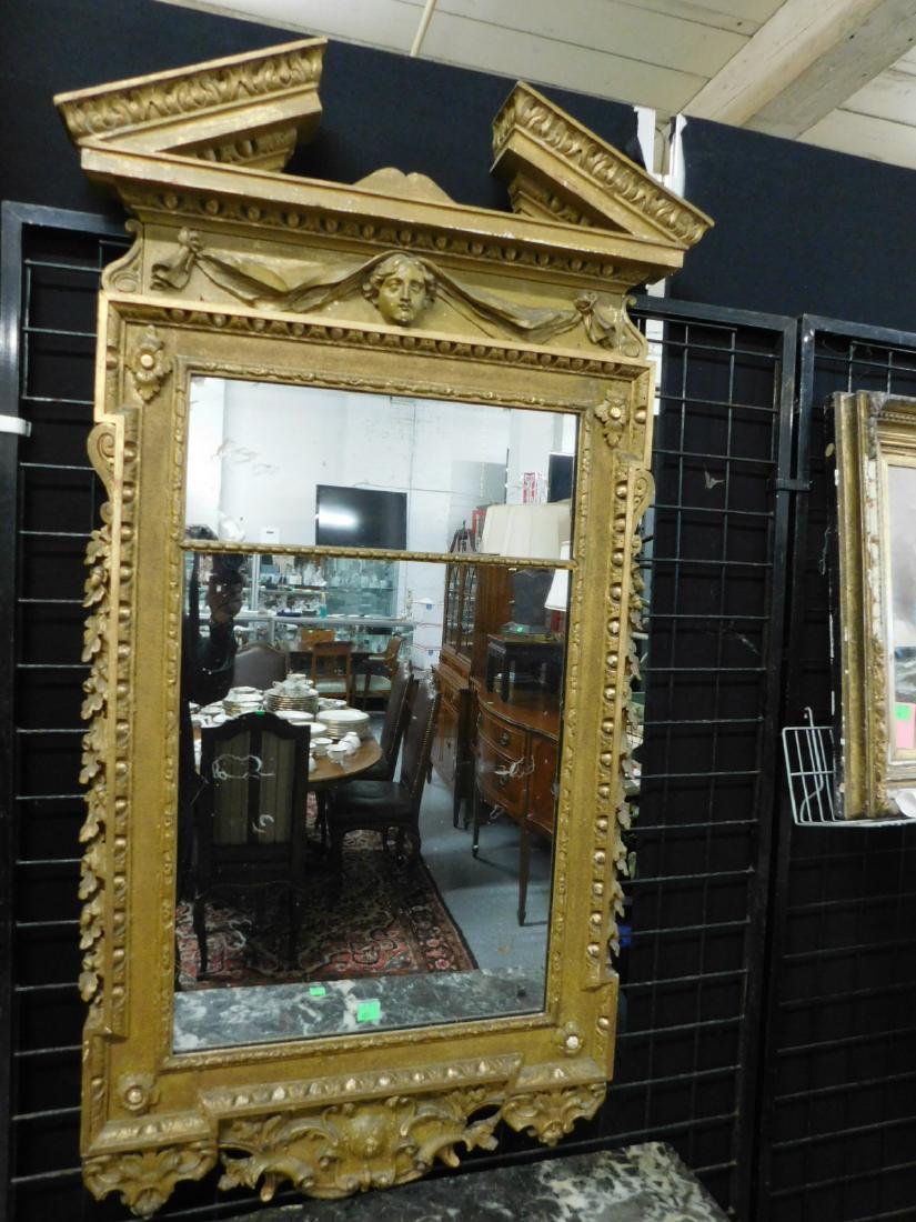 Continental Classical Pier Mirror: Continental Classical Pier Mirror, gilt and carved wood and Gessoed frame, broken arch pediment over mark and drape frieze, two part narrow framed by rosette corners foliate, gadroon and other borders