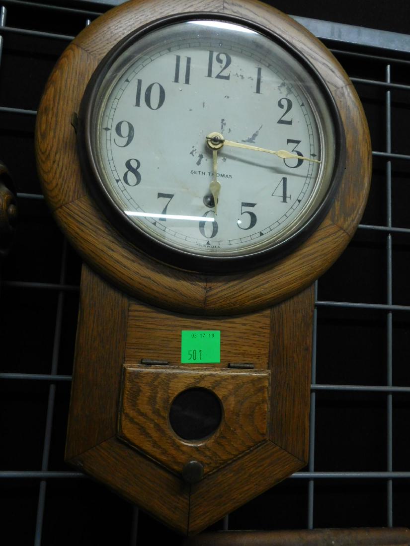 Seth Thomas School House Clock: Seth Thomas School House Clock, oak, painted tin dial, time only movement, pediment base with pendulum door, late 19th C, 11 11/2" x 18" x 5". CONDITION: Paint losses on dial, running condition unknow