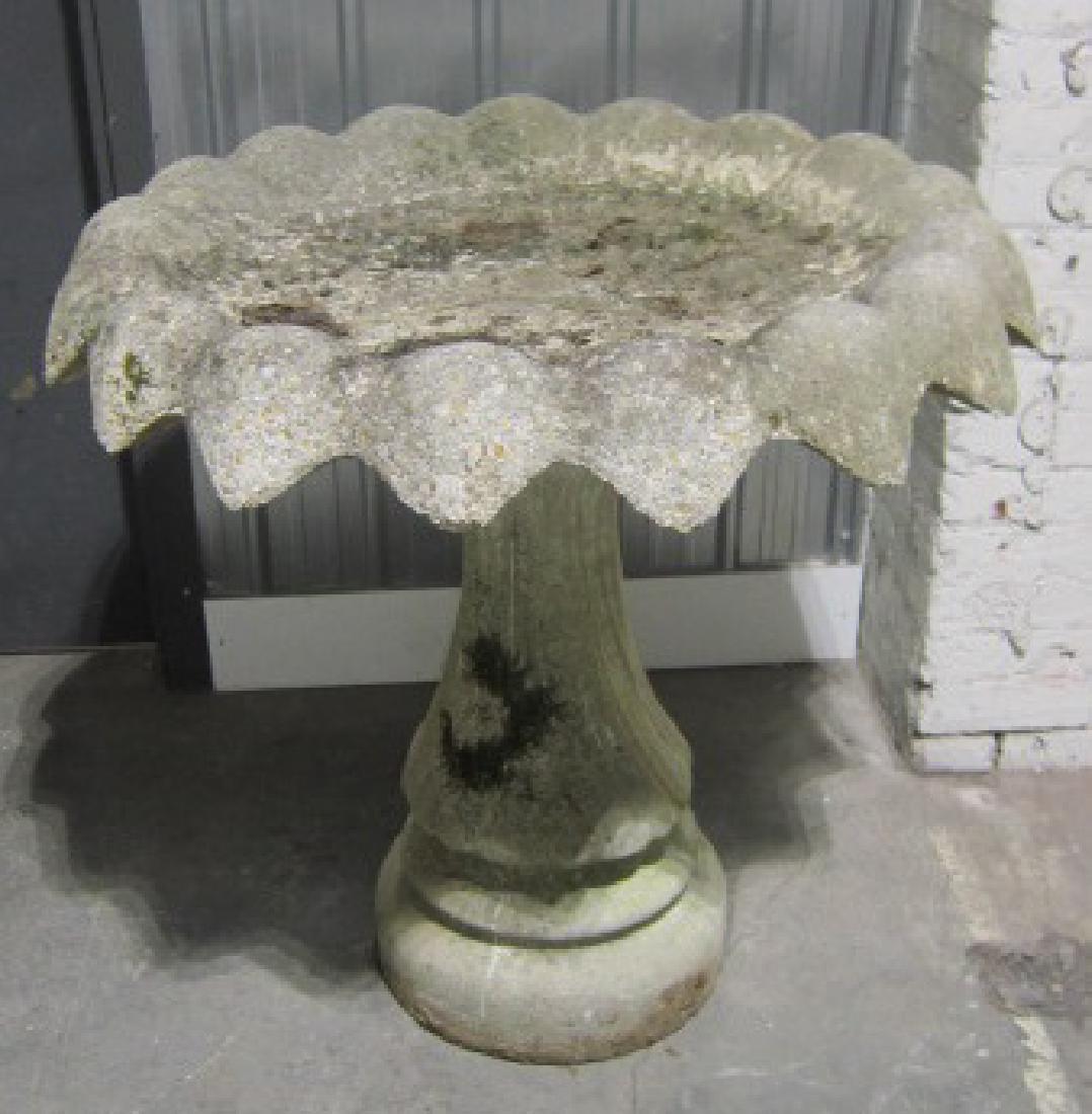 Large Vintage Concrete Garden Bird Bath: Large Vintage Concrete Garden Bird Bath, flower pedal form top, 33"d, with a spiral form pedestal on a round base, 32"h. CONDITION: Bird bath top is weather worn, especially rim, dirt and leaf debris