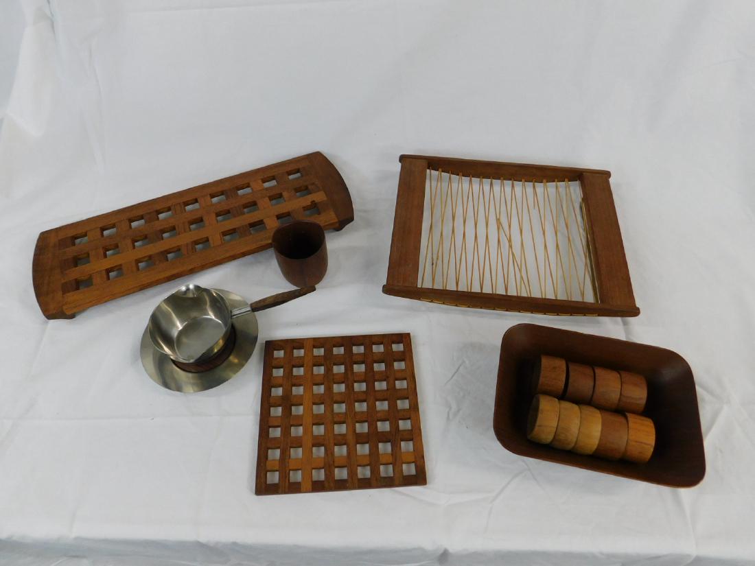 MCM Teak Serving Items: MCM Teak Serving Items: Lot consisting of: a long Dansk teak tray/trivet, a square teak trivet marked "Danmark" (likely early Dansk); a rattan & teak trivet marked "Siam Teak Denmark"; a teak turned w