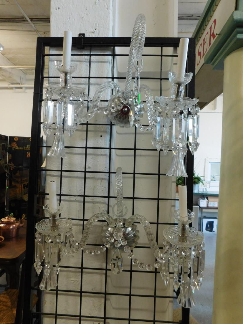 Pr Crystal Wall Sconces: Pair Crystal Wall Sconces, possibly Baccarat, three light, features spiral pattern glass arms and scrolls, pendant crystal bells, cut spears and beads, 20th C, approximately 20" x 14" x 8". CONDITION: