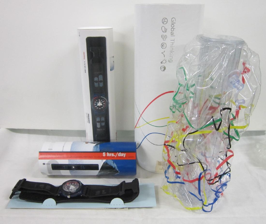 2 Swatch Watches In Original Cardboard Tubes: Two Swatch Watches In Original Cardboard Tubes, both new old stock, with folded information sheets including: P. (eter) Bauer Freeride, SHN 101 (key watch function) with poster inside, plus "The Club"