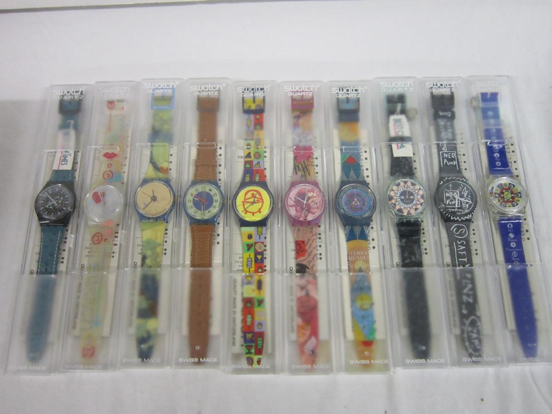 10 Swatch Watches In Original Cases: Ten Swatch Watches In Original Cases, all in hard plastic cases with folded renumbered information sheets including: African BBQ, GN 179,For Your Heart Only, GR 127, Tarot, GN 131, Samtqeist, G6 136, 