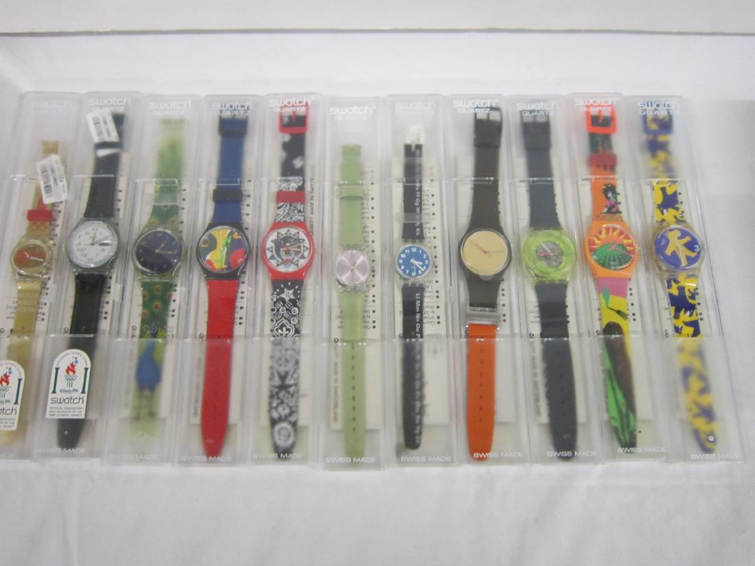 11 Swatch Watches In Original Cases: Eleven Swatch Watches In Original Cases, all in hard plastic cases with folded renumbered information sheets including: Alphabet, LK 156, Techno Sphere, GK 101, Green Lacquer, GM 709 ( Day / Date ), a