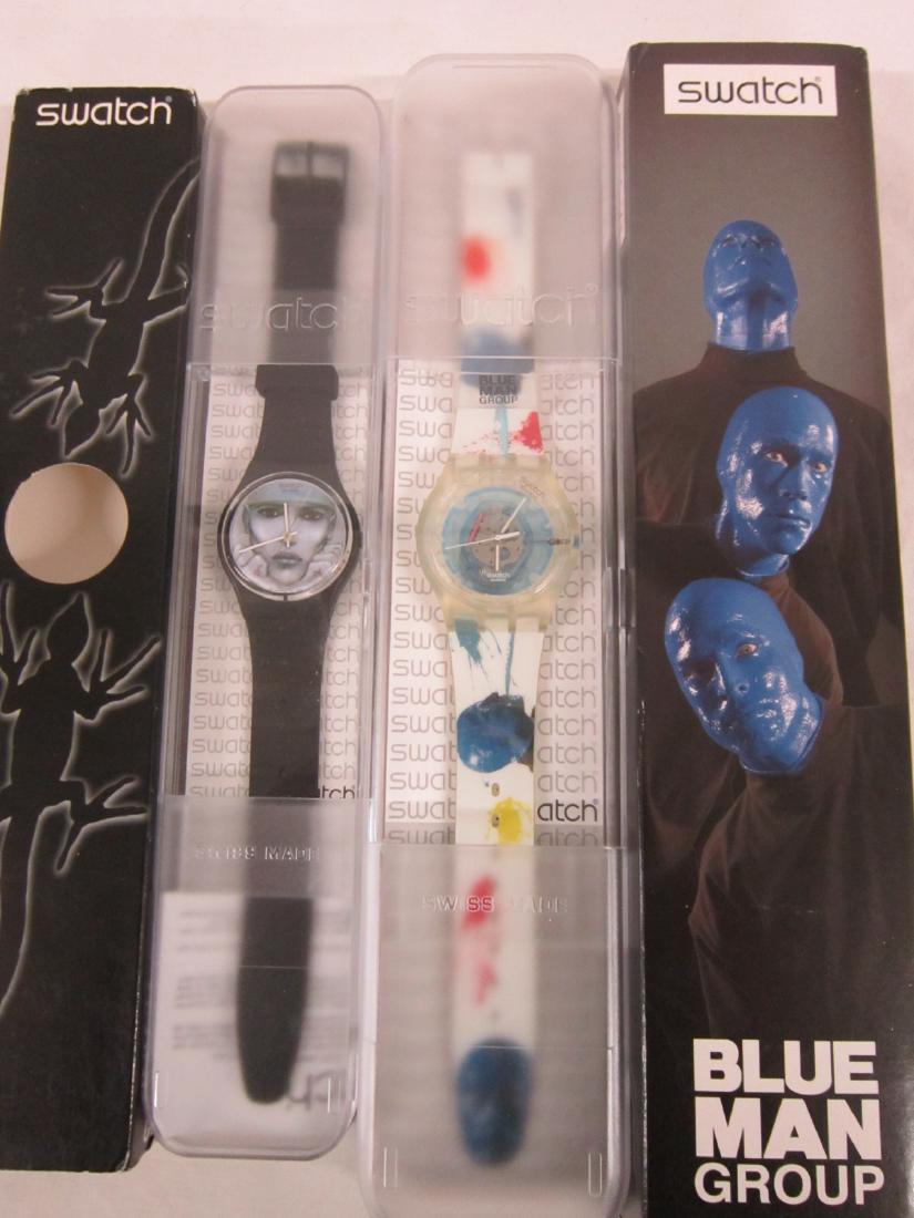 2 Swatch Watches In Original Cases: Two Swatch Watches In Original Cases. both new old , in hard plastic cases with folded information sheets including: Too Many Memories, GZ 217 and Swatch Blue, SUJK 104C (Blue Man Group). Note: We Do