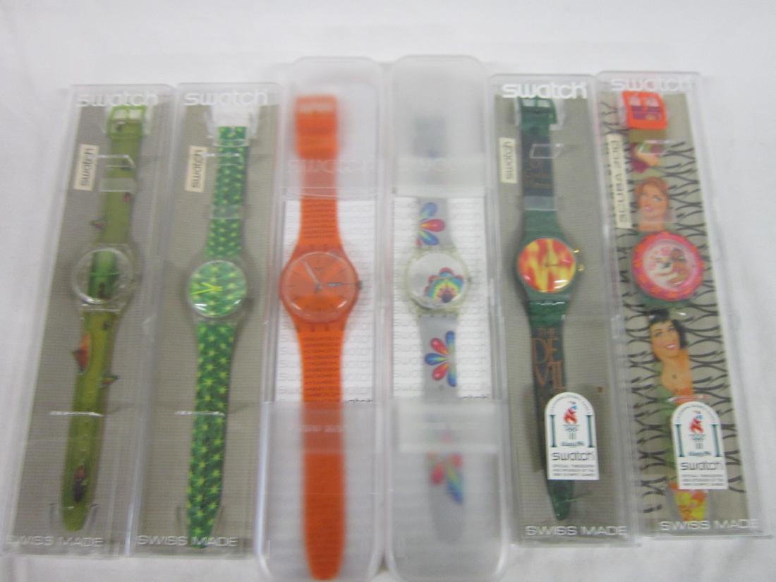 6 Swatch Watches In Original Cases: Six Swatch Watches In Original Cases, new old stock, in hard plastic cases with folded information sheets including: Beach Virgin, SDG 104 (scuba, glow in the dark), The Devil, GG 900(back light / loo