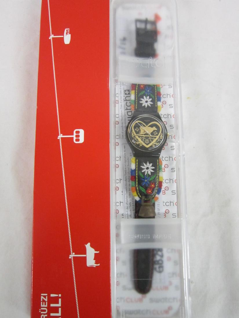 Die Glocke Swatch In Original Case: Die Glocke Swatch In Original Case,"The Bell", new od stock, GB 285, in hard plastic c ase with red cardboard over sleeve, folded information sheet, watch has gold tone dial with pastoral motif, leath