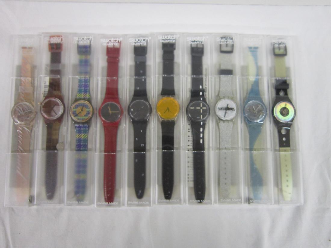 10 Swatch Watches in Original Cases: 10 Swatch Watches in Original Cases, new old stock, all in hard plastic cases, with folded information sheets including: Seppia, GB 184, 1998, Fat Free, GN 167, 1997, World Inc, GK 264, 1998, Just Som