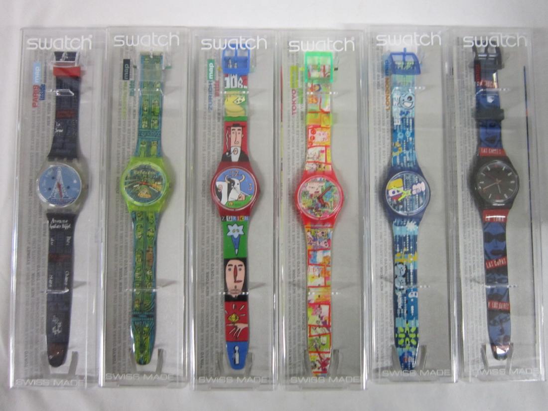 6 Swatch Watches In Original Cases: Six Swatch Watches In Original Cases, Map Inside, new old stock, in hard plastic cases with folded information sheets including: Titi Parisian (Paris map), GK 276,Passage To Brooklyn (Brooklyn map), G
