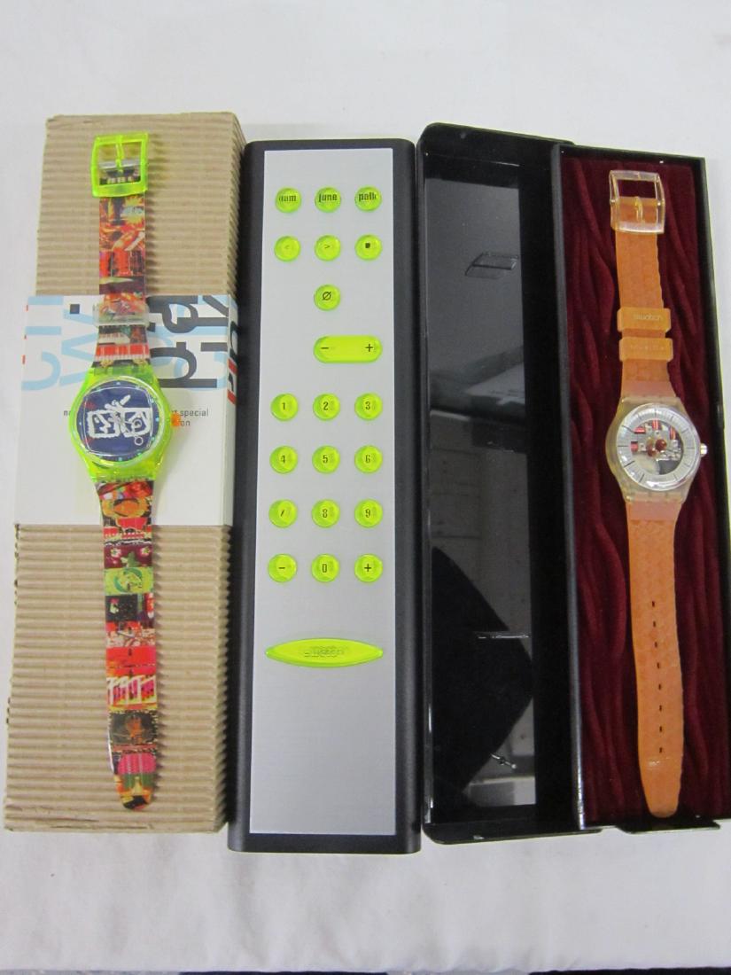 2 Swatch Watches Musical In Original Cases: 2 Swatch Art Special 1996 "Zapping" by Nami June Paik, SLZ 104; Limited Edition in hard plastic, Television Remote Control form case with folded information sheet with cardboard over case, plus Peter