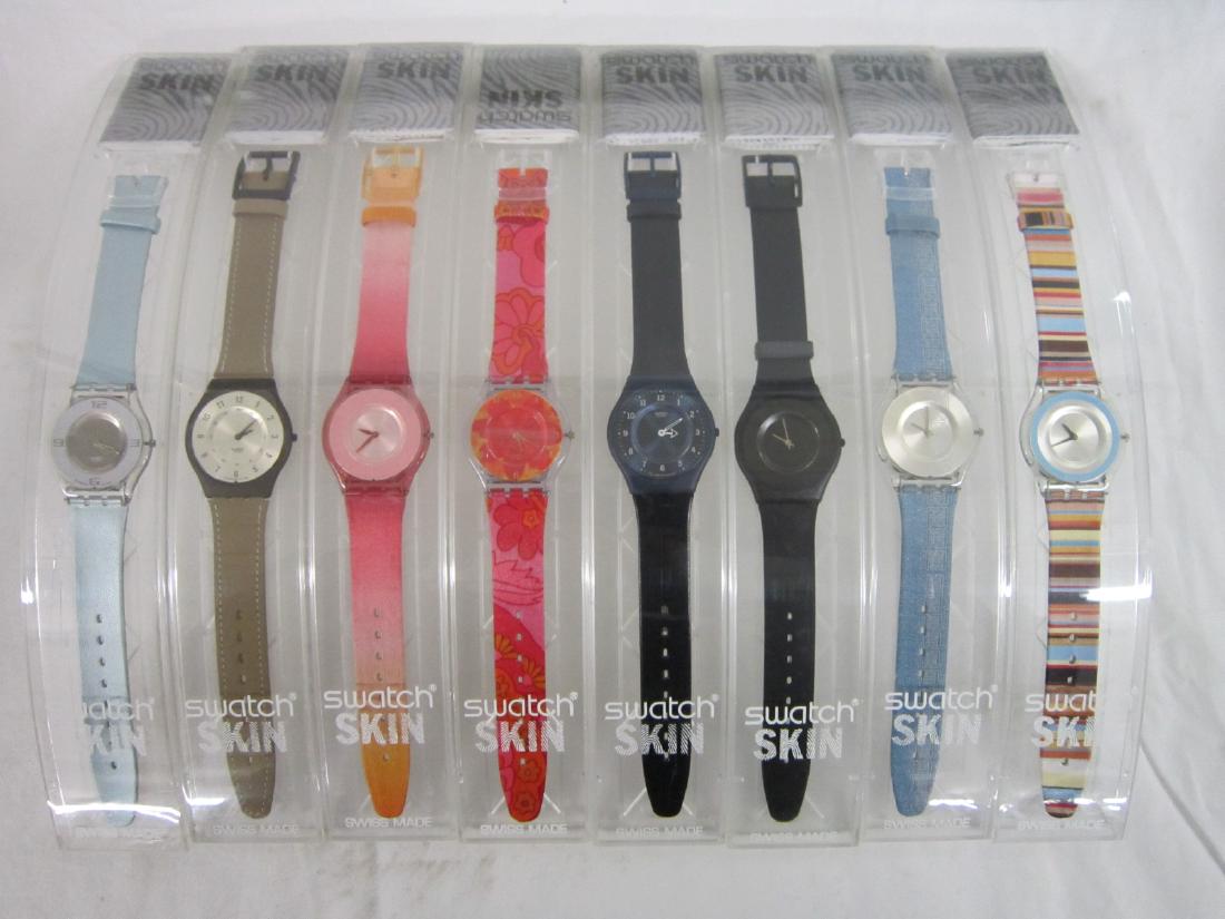 8 Swatch Watches Skin In Original Cases: Eight Swatch Watches Skin In Original Cases, new old stock, all in curved hard plastic cases with folded information sheets including: Thin Sider, SFN 102, Dream Like, SFK 106, Black Out Too SFB 100,