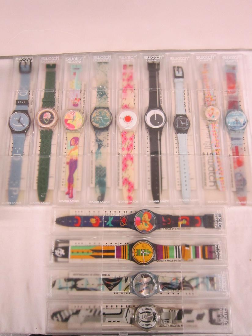 13 Swatch Watches In Original Cases: Thirteen Swatch Watches In Original Cases, new old stock, in hard plastic cases with folded information sheets including: Travel Diary, GN 195, Call a Date, GN 180, Dreaming Houses, GN 194, Overshadow