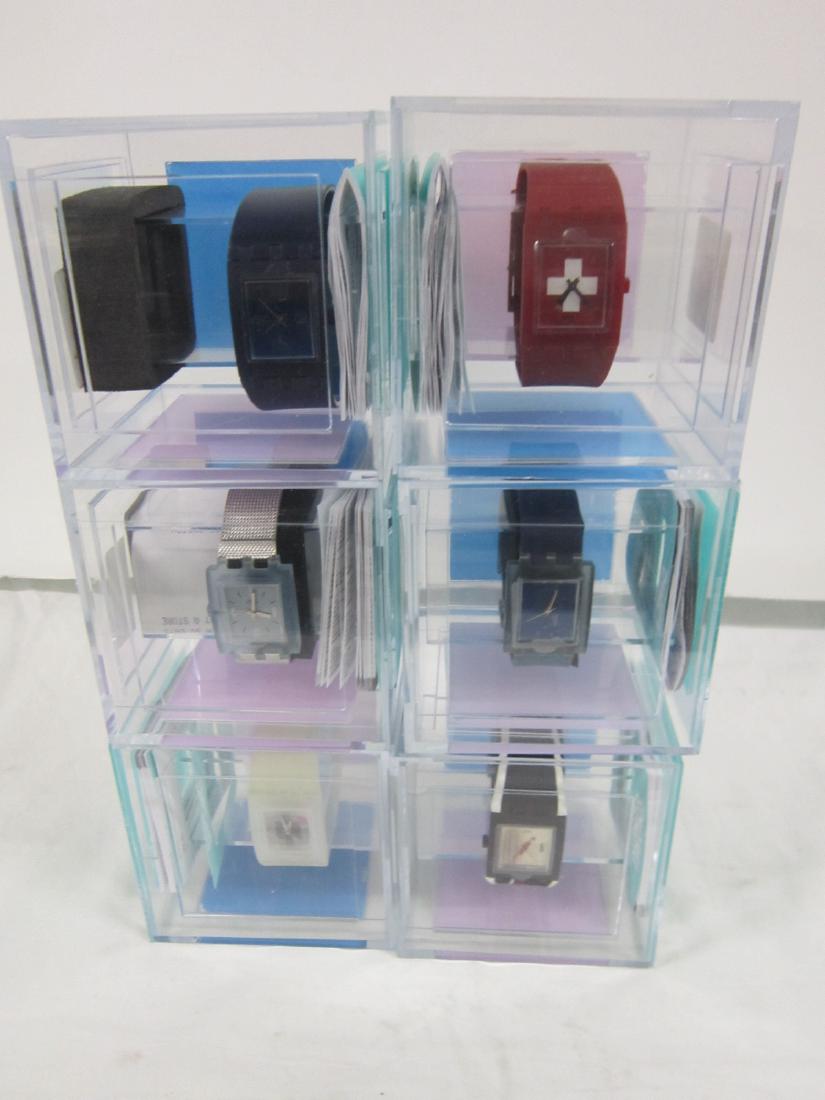 6 Swatch Watches "Square!" In Original Cases: Six Swatch Watches Irony In Original Cases, new old stock, color cardboard and hard plastic top cases with folded information sheets including: Subliminal, SUBK 100, Day Care, SUBN 102M, Aqua Vitae, S