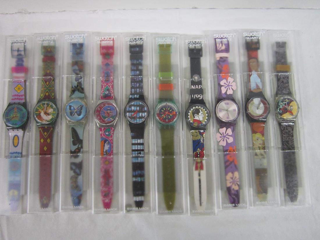 10 Swatch Watches In Original Cases: Ten Swatch Watches In Original Cases, new, old stock, in hard plastic cases with folded information sheet including: Overtime, GB 183, 1997; Dehli, GX 125, 1993; Sky Fly, GK 347, 2001; Ineluctable, G6