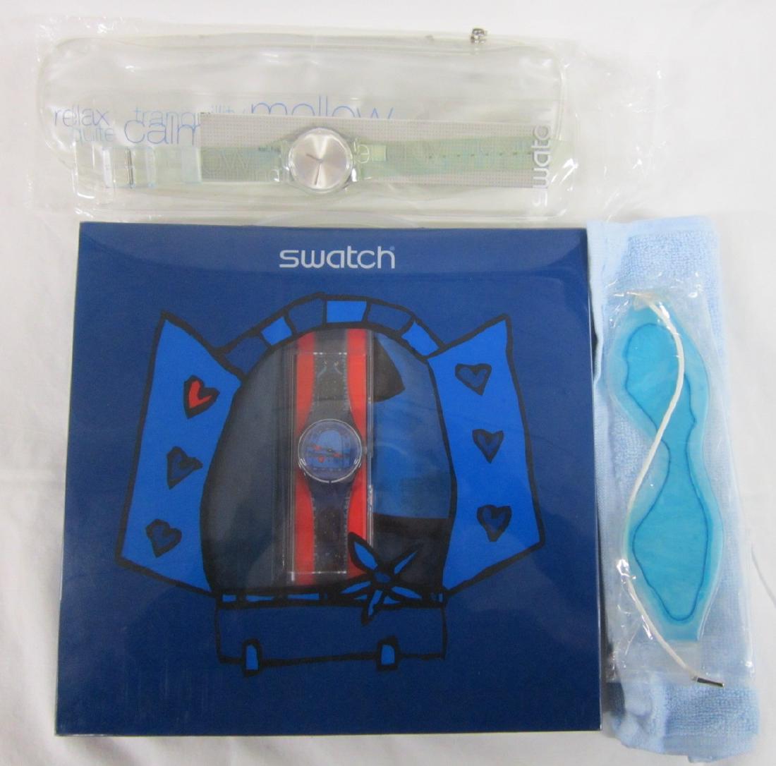 2 Swatch Watches Both in Original Cases: Two Swatch Watches Both in Original Cases, new old stock including: Don't Disturb, GN 203,2002 in soft plastic zippered case with gelled eye mask and washcloth, plus Amour total, GN 196, 2001 in plast