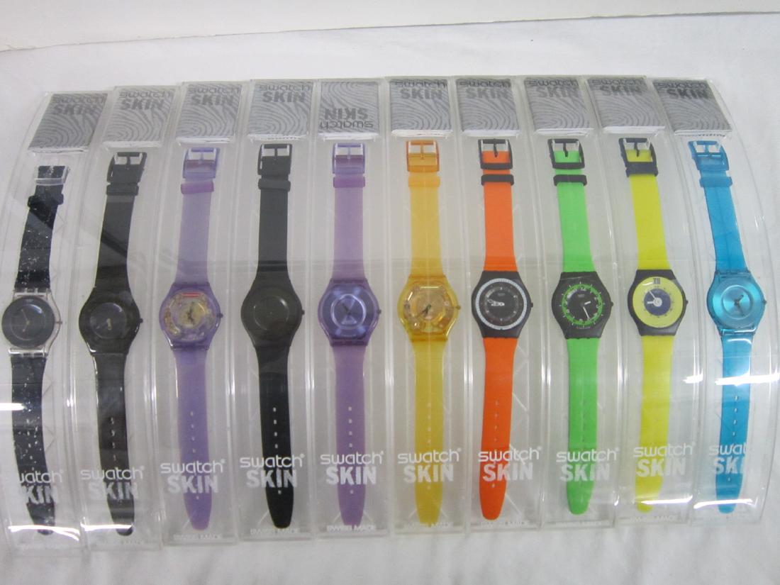 10 Swatch Watches Skin In Original Cases: 10 Swatch Watches Skin In Original Cases, new old stock, in hard plastic cases with folded information sheets including: Yellow Jelly Skin, SFJ 101, New Blue Jelly Skin, SFN 107, New Purple Jelly Skin