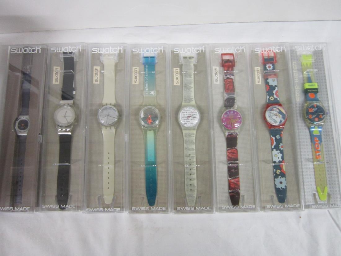 8 Swatch Watches In Original Cases: Eight Swatch Watches In Original Cases, new old stock, in hard plastic cases with folded information sheets including: Movements (stop-watch), SSK 102, Roboboy, GR 135, Be Mine, GK 291, Page 1985, GK