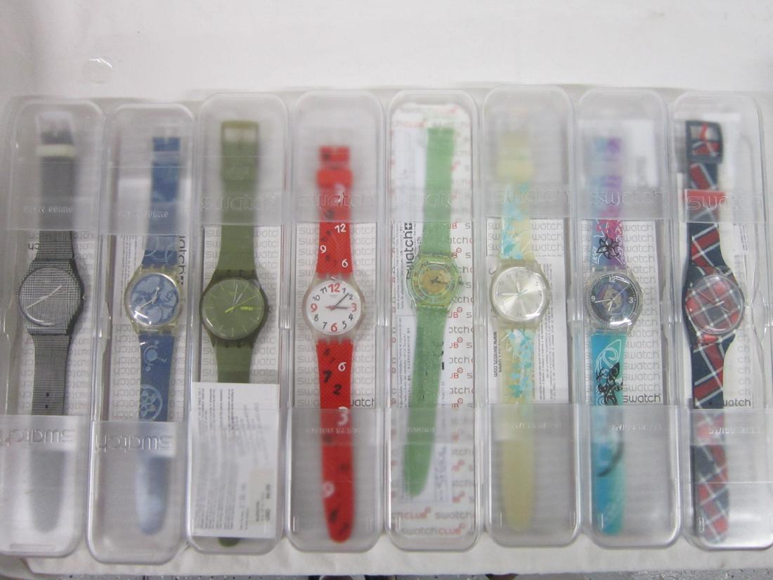 8 Swatch Watches In Original Cases: Eight Swatch Watches In Original Cases, new old stock, in hard plastic cases with folded information sheets including: Verdor,k SFG 106, Color Kilt, SUON 106, Hawaiian, SUJK 122, In The Skyk, SUJK 140