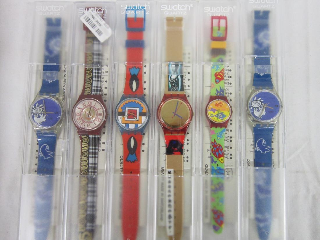 6 Swatch Watches In Original Cases: Six Swatch Watches In Original Cases. likenew, in hard plastic cases with folded renumbered information sheets including: Poissoniere, LR 111, two Vive La Paix, GK 206, Kimiko, GR 123, Paella, GN 129 