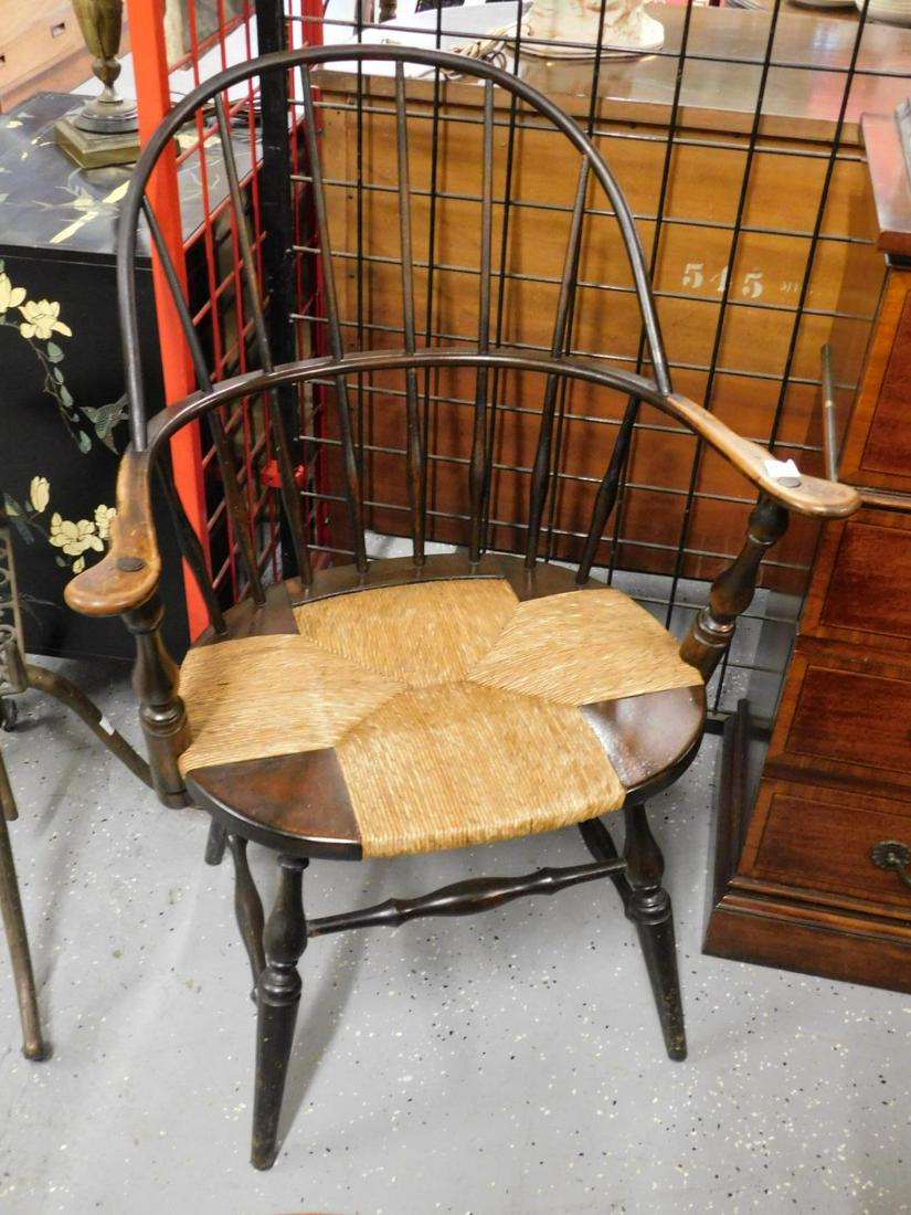 Windsor Style Arm Chair: Windsor style arm chair, mahogany stained mixed woods, bow back, rush seat, turned splayed legs with stretchers, 37 1/4" h., early 20th c. Condition; finish wear on arms