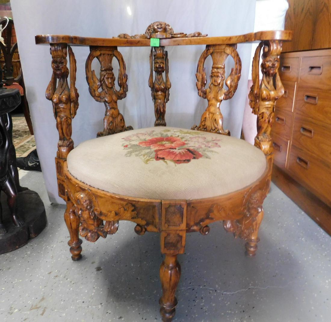 Georgian Style Corner Chair: Georgian style corner chair mahogany, elaborate carvings to include Putti mask, winged caryatid and acanthus scrolls; beige floral needlepoint slips seat, 19th c., H 30 1/2". CONDITION: Very good, on 