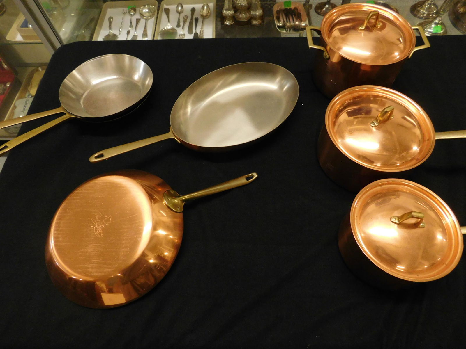 7 Piece Copper Pot Set: 7 piece copper pot set by "Paul Revere USA" including (2) 8 1/2" pans, 10 1/2" pan, 8 1/2" x 12" oval pan, 7" and 7 1/2" covered pots and 7 3/4" covered deep pot, mid 20th c. Condition; used but good