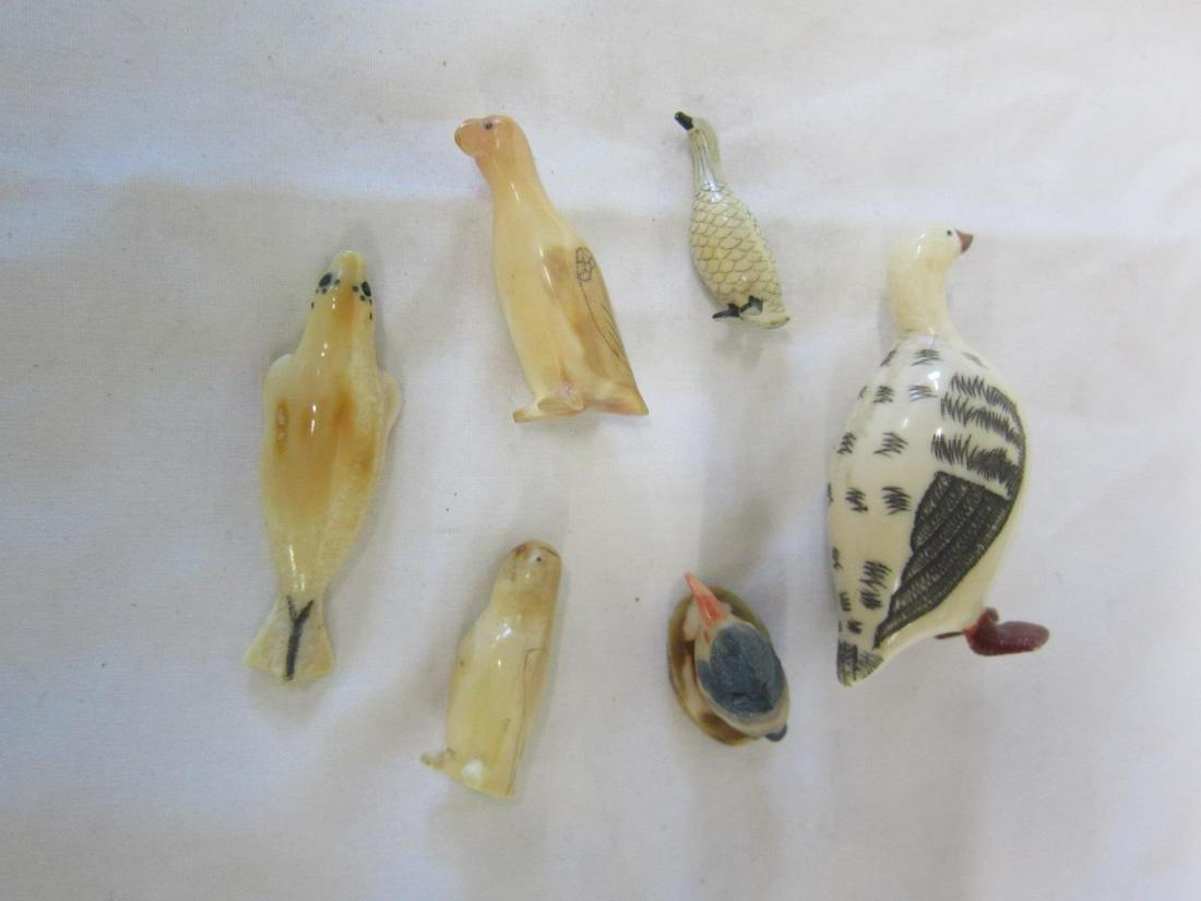 6 Miniature Bird Carvings: Six Miniature Bird Carvings, includes: Inuit 2" tooth carved seal, 1 1/2" penguin and 1 1/2" bird; Chinese tusk carved and ink stained 2 1/4" and 1 1/4" geese and a plastic polychromed bird on tusk ba
