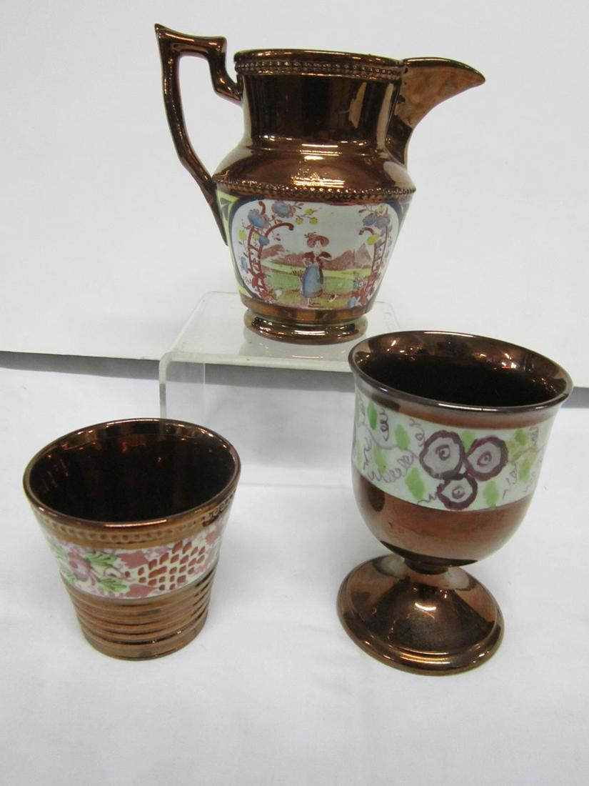 3 Pieces 19th C. Copper Luster Ware: Three Pieces 19th C. Copper Luster Ware including: small pitcher with oval pommel scenes front and back, allegorical scenes, 4 1/2"h x 5 1/4" d (at handle), footed cup with grape ad vine design on whi