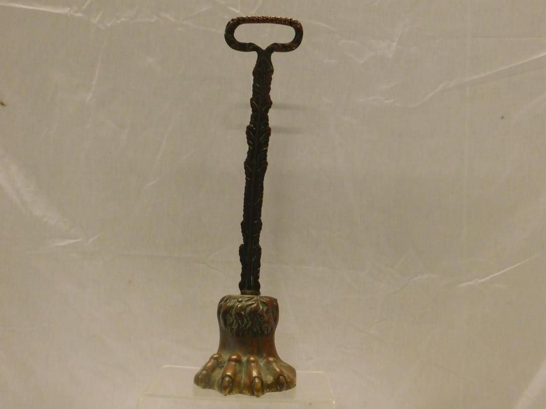 Bronze Door Stop: Bronze door stop, loop crested feathered column upon cast iron claw base with lead liner. 19th c., 14 3/4" h. Condition; tarnished