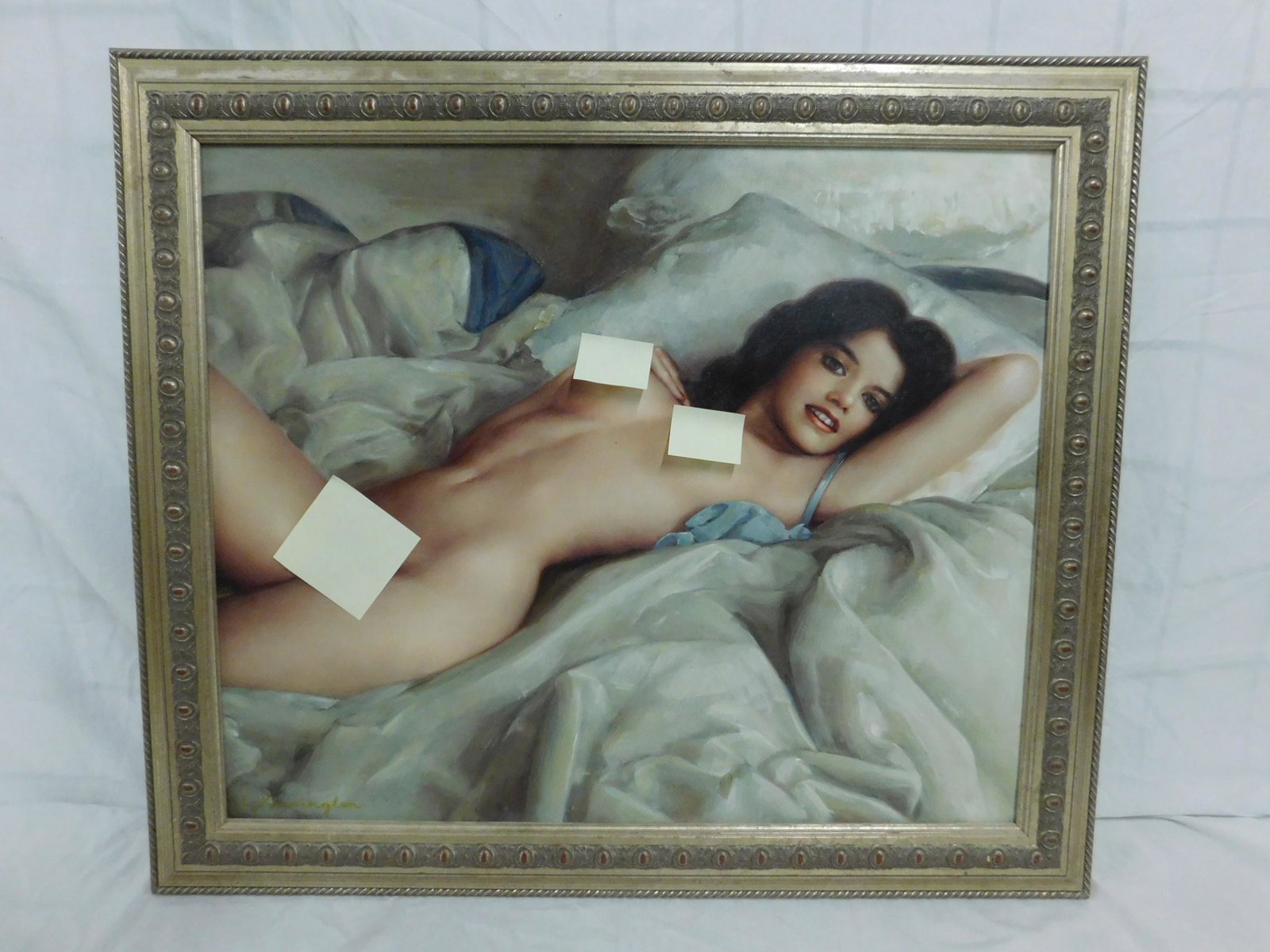 L Kennington Oil on Canvas Reclining Female Nude: A framed, contemporary oil on canvas of a reclining female nude, lying prone in a luxuriant mound of bedclothes. Signed L Kennington lower left. From the collection of Albert J Raman. Size: stretcher 