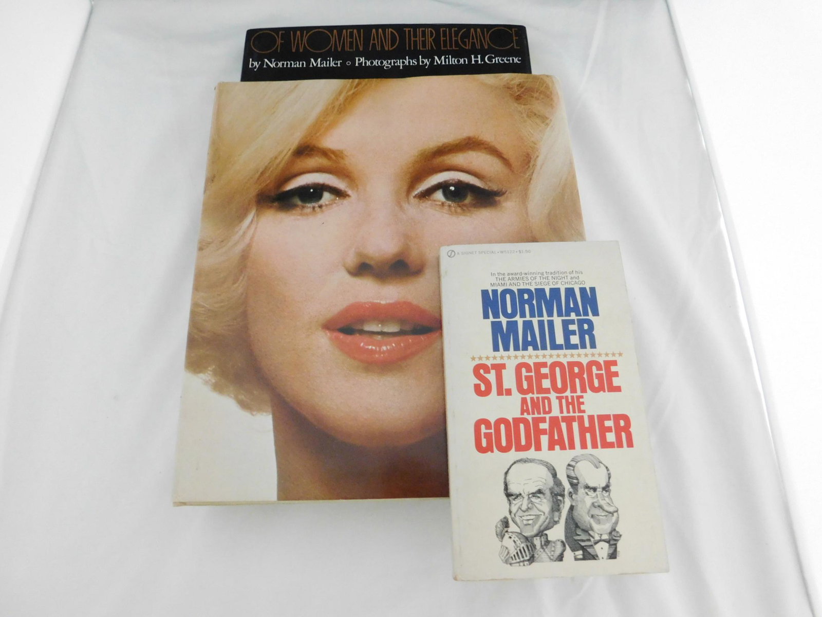 Norman Mailer Woman & Their Elegance Signed: [3 items] Mailer, Norman & Greene, Milton, Of Women and their Elegence, Simon & Schuster, New York, 1980. First printing, signed by the author on the title page. Photographs by Milton H Greene. Along 