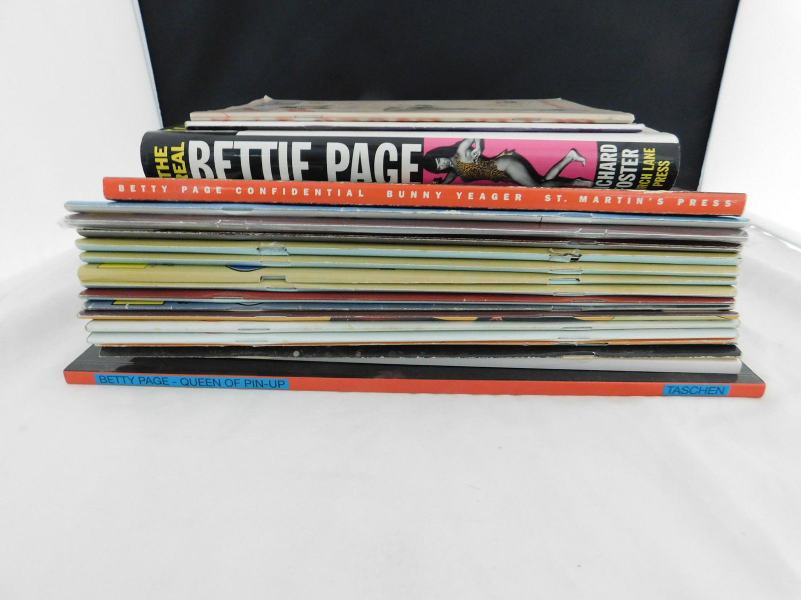 Bettie Page / The Betty Pages / Tease Magazine Lot: A lot of Bettie Page-related books and magazines, including: Foster, Richard. The Real Bettie Page, Birch Lane Press, 1997; Yeager, Bunny. Betty Page Confidential, St Martin's Press, New York, 1992; B