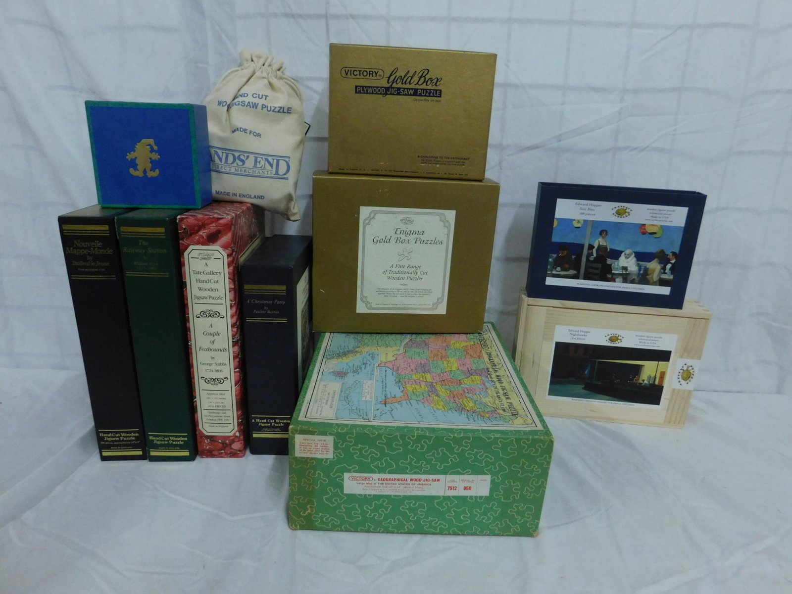 Hand-Cut Wooden Jig Saw Puzzles: [11 items] A collection of wooden jigsaw puzzles, including puzzles by Optimago, Artifact, Victory and others. please refer to photos for complete contents of lot. From the collection of Albert J Rama