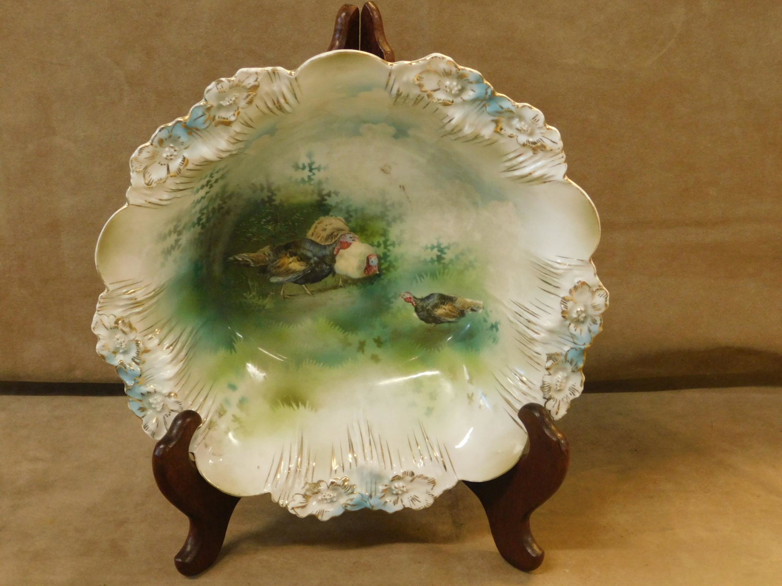 R. S. Prussian Bird Fruit Bowl: R. S. Prussian Bird Fruit Bowl, Red Star mark, floral embossed scalloped rim, transfer print interior of three grazing turkeys, 3"h, 11"d. CONDITION: Very slight rim gilt loss, very tiny rim imperfect