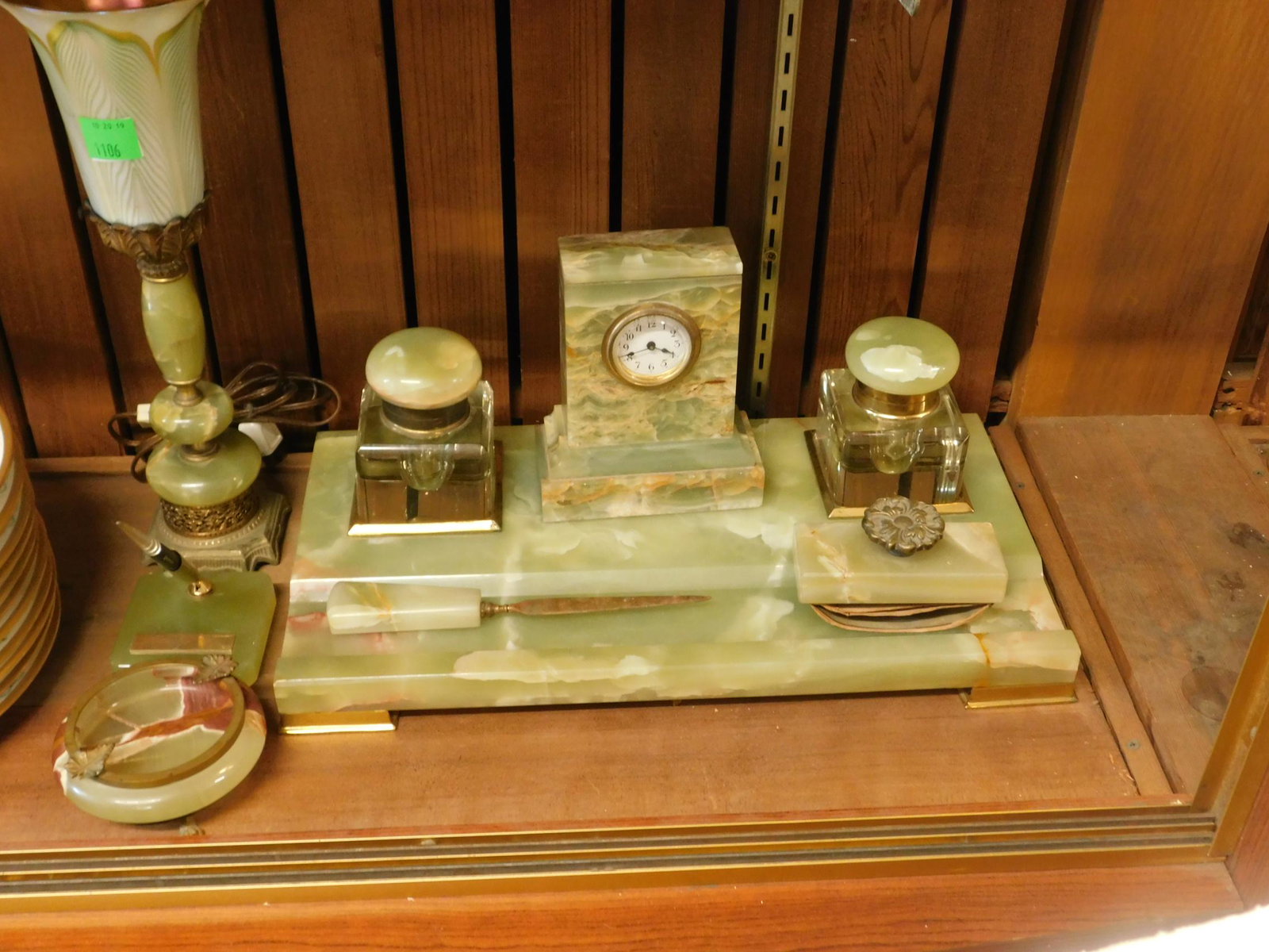 Assembled Green Onyx Art Deco Desk Set: Consisting of an onyx and brass pen rest/stand holding two onyx-lidded crystal inkwells, a desk/mantle clock, a rocking blotter, letter opener, ashtray, Sheaffer fountain pen holder, and a desk lamp w