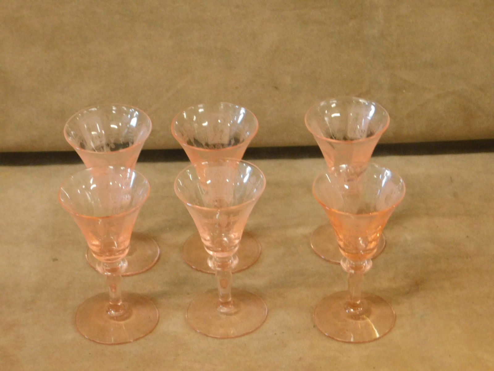 Heisey Flamingo Pink Trojan Cordials: Heisey Flamingo Pink Trojan Cordials. A set of six cordial glasses by Heisey Glass in their #3366 Trojan stem, in Flamingo Pink, decorated with their #445 Trojan etching. Each marked with the diamond-