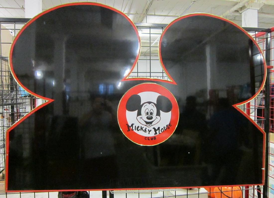 Mickey Mouse Club Overhead Entrance Sign: Mickey Mouse Club Overhead Entrance Sign, black lacquer with red tape accent, brass border raised Mickey Mouse insignia at center, Mouseketeer hat form, on back "Tommy" painted. Note: This may have be