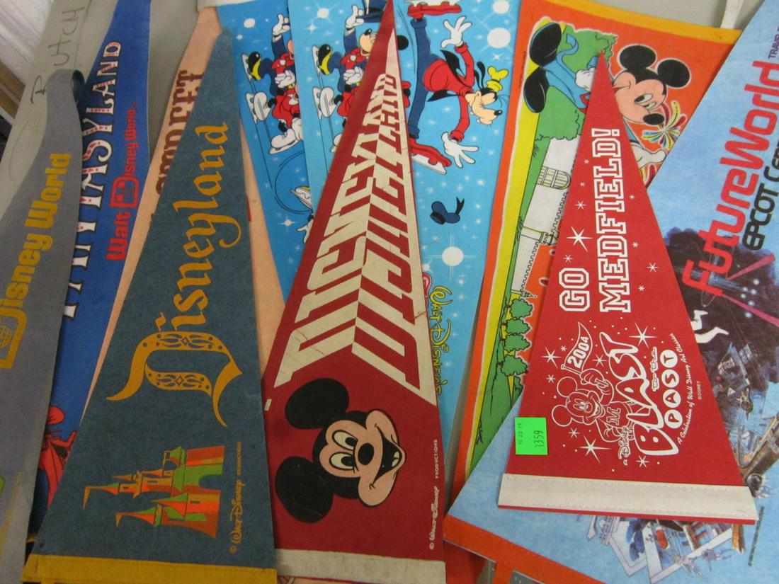 11 Disney Pennants: Eleven Disney Pennants including: one framed "Disneyland 25" and ten loose including: Go Medfield!, 18", two Disneyland, 23", one Walt Disney World, 23", one Future World, 29", two W.D. Great Ice Odys