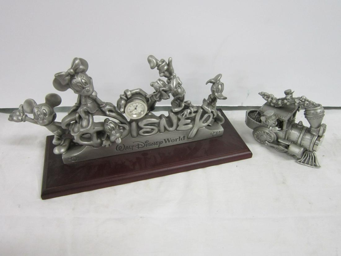 2 Pewter Disney Figures Clocks: Two Pewter Disney Figures Clocks including: large Walt Disney World with Mickey, Minnie, Donald, Daisy, Pluto and Goofy with 7/8" d clock at center, on wood base L/E 1649 / 3000, 4" x 10" x 6"h, in or