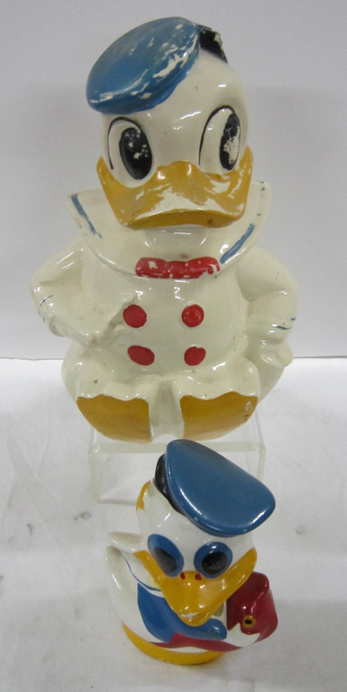 Vintage Donald Duck Cookie Jar & Bank: Vintage Donald Duck Cookie Jar & Bank including: Celebrate Donald Duck ceramic cookie jar, 12"h and Donald Duck with fish ceramic bank, 6"h, both hand painted. CONDITION: Some paint loss, especially o